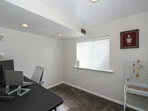 Carpeted office space with recessed lighting, baseboards, and visible vents