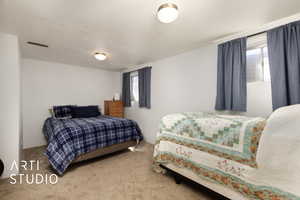 Carpeted bedroom with visible vents and multiple windows