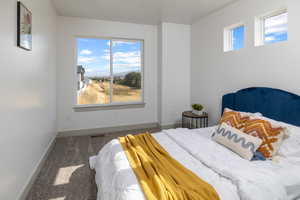 Bedroom featuring baseboards, carpet, and visible vents