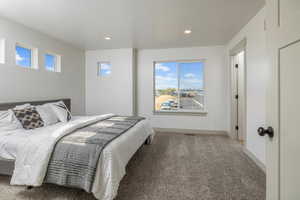 Bedroom featuring carpet flooring, recessed lighting, and baseboards