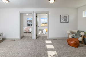 Carpeted bedroom featuring baseboards and visible vents