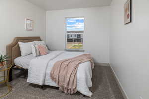 Bedroom with baseboards and carpet