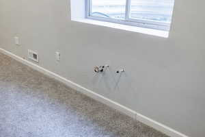 Interior details featuring baseboards, carpet flooring, and visible vents