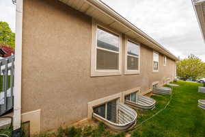 View of home's exterior with a lawn and stucco siding
