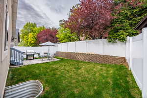 View of yard with a patio and a fenced backyard
