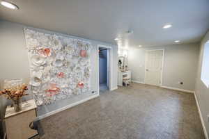 Carpeted empty room featuring baseboards, recessed lighting, and visible vents