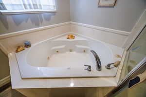 Full bathroom with a jetted tub