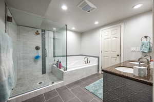 Full bathroom with recessed lighting, tile patterned floors, a shower stall, and a garden tub