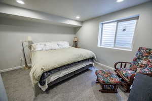 Carpeted bedroom with baseboards and recessed lighting
