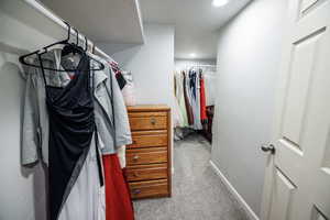 Walk in closet with carpet flooring