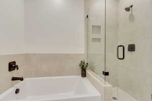 Bathroom with a garden tub and a stall shower
