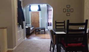 Carpeted dining room with baseboards and arched walkways