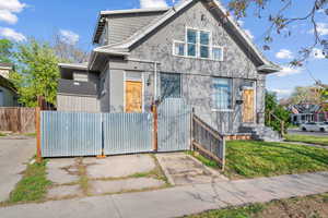 Bungalow-style house featuring a gate and fence private yard