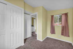 Unfurnished bedroom featuring carpet floors and baseboards