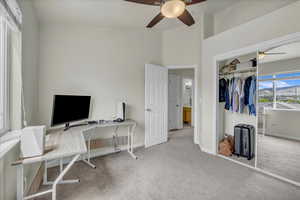 Office space with carpet flooring, a ceiling fan, and baseboards