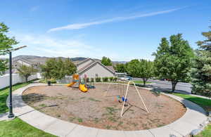 Exterior space featuring fence, a mountain view, and playground community