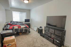 Carpeted bedroom with baseboards