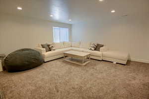 Living area featuring carpet floors, recessed lighting, and baseboards