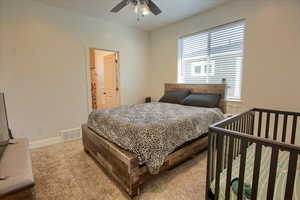 Bedroom featuring visible vents, carpet, ceiling fan, and baseboards