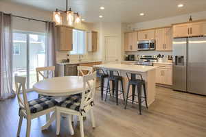 Dining area featuring recessed lighting, light wood-style floors, a chandelier, and baseboard heating