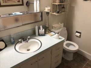 Bathroom with vanity, baseboards, tile patterned floors, and toilet