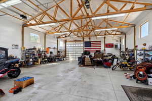 Garage featuring a garage door opener and a workshop area
