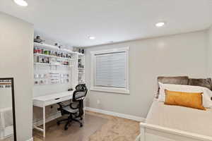 Carpeted bedroom with recessed lighting