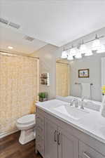 Bathroom with wood style floors, toilet, and vanity