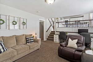 Living room with carpet floors,  ample space, and built in desk for two.