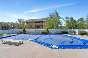 Pool with fence and a patio area