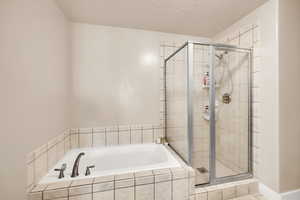 Primary Bathroom featuring a bath and a stall shower