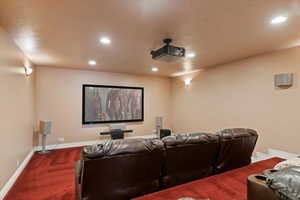 Cinema featuring recessed lighting, baseboards, and dark colored carpet