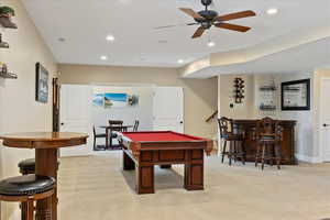 Rec room with baseboards, billiards, light colored carpet, recessed lighting, and a dry bar