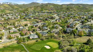 Drone / aerial view with a residential view, a mountain view, and view of golf course