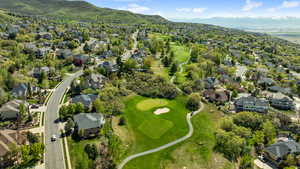 Bird's eye view featuring a residential view, a mountain view, and view of golf course