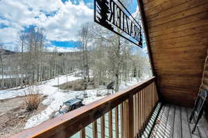 View of snow covered back of property