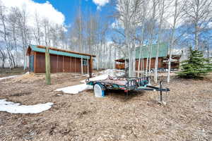 View of yard featuring an outdoor structure and a pole building