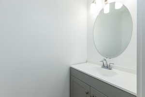 1/2 Bathroom on the living room floor featuring vanity