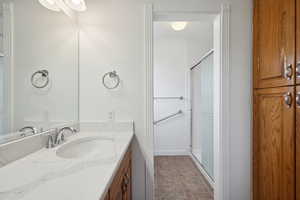 Bathroom featuring vanity and a stall shower