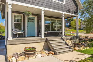 Doorway to property with covered porch