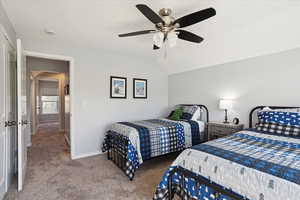 Bedroom featuring carpet floors, a ceiling fan, baseboards, and lofted ceiling