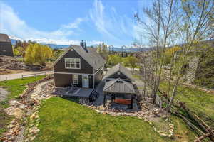 Rear view of house featuring a gazebo, a yard, and a patio area