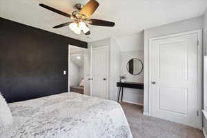 Carpeted bedroom featuring baseboards and ceiling fan
