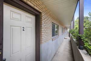 Doorway to property with brick siding