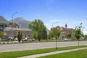 View of street with street lights, a mountain view, and sidewalks