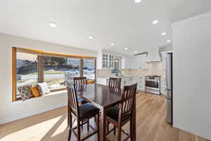 Dining space featuring recessed lighting, White oak wood floors, and baseboards