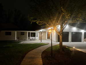 View of front of home with a lawn, concrete driveway, and brick siding
