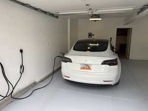 Garage featuring a garage door opener. electric car charger