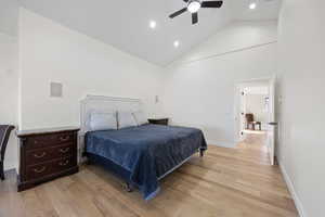 Bedroom with ceiling fan, white oak wood flooring, high vaulted ceiling, recessed lighting