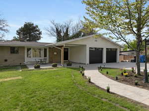 Single story home featuring fence, a front yard, brick siding, an attached garage, and driveway